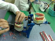 Magda is modelling trial upper and lower removable complete dentures in wax.